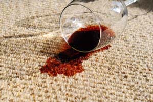 Red wine spilled on a white carpet